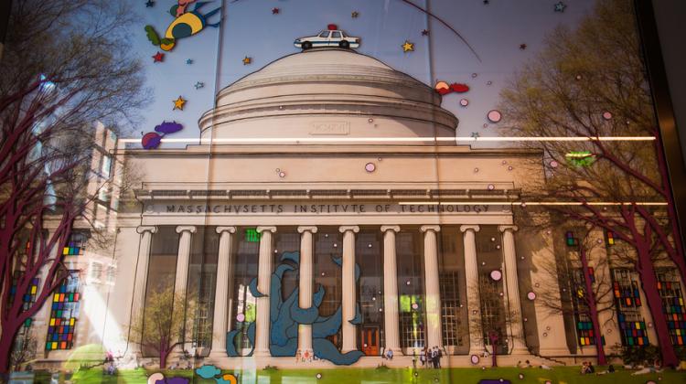 Image taken from Killian Court with Building 10 and the MIT dome centered in the background. Overlaid on the photograph are whimsical illustrations such as the MIT Hack of a police car on the dome.