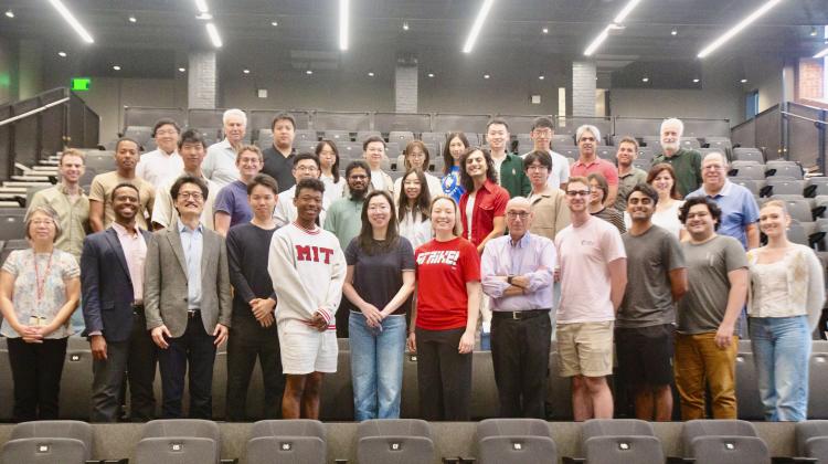 A group of people standing in an auditorium for a picture.