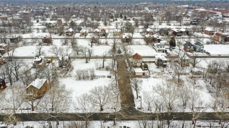 Image of Detroit, snow is on the ground and single family homes are distanced from one another to show that lots are vacant and not under development.
