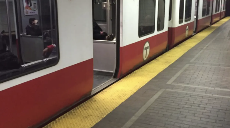 An MBTA Red Line train at Park Street Station. Doors are open and one can make out passengers inside the cars but ridership is low.
