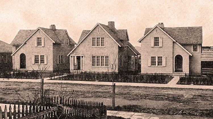 A row of newly built homes in a sepia-toned photograph