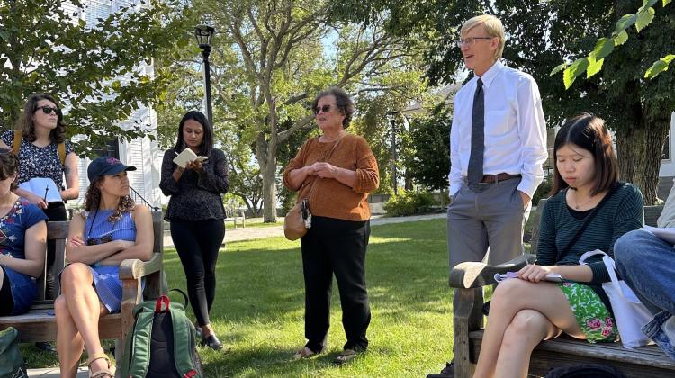 Students and community leaders gather in green space to converse