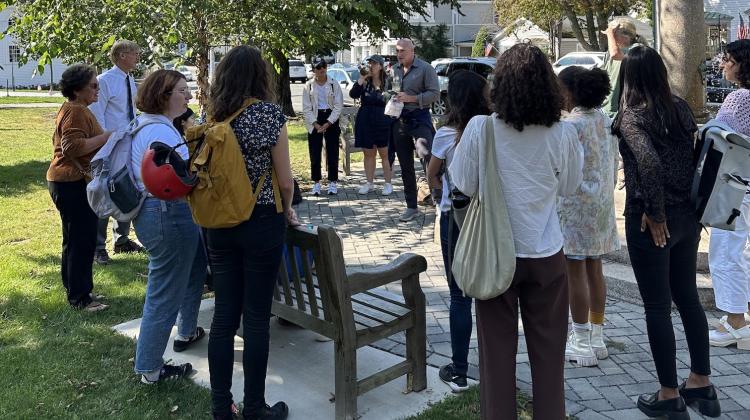 Students gather around a square in Manchester by the Sea to learn about the community