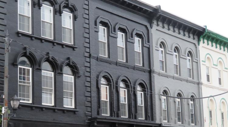 Picture of townhouses, each painted in a shade from black to white, showing a grayscale effect