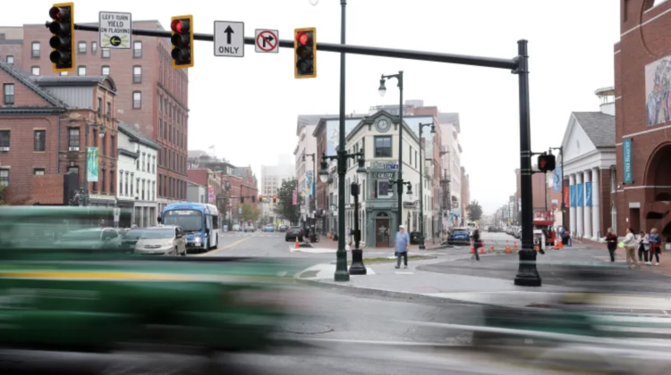 An intersection in Portland Maine with slow shutter speed to make passing traffic blurred
