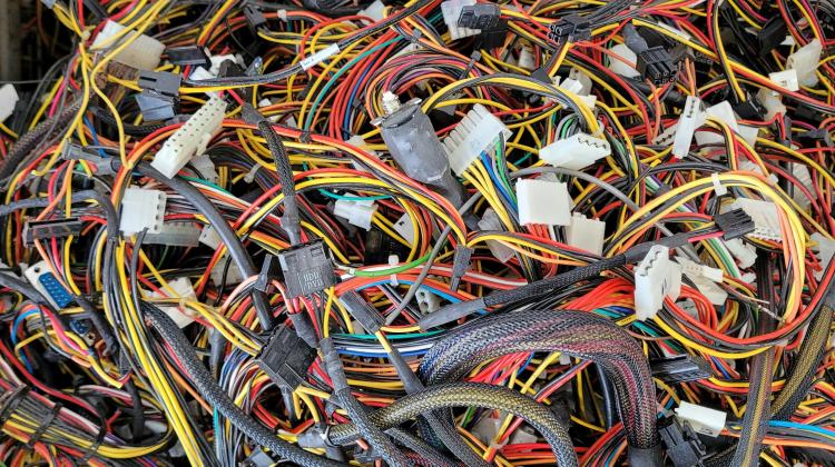 A tangle of multicolored wires with various types of connection points, all e-waste