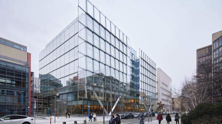 Photo of the facade of the MIT Schwarzman College of Computing building, which features a shingled glass exterior that reflects its surroundings