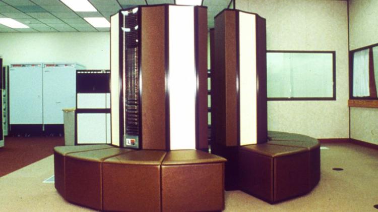 Image of an old super computer cluster, to modern viewers this might look more like a circular bench surrounding a central lighted pillar