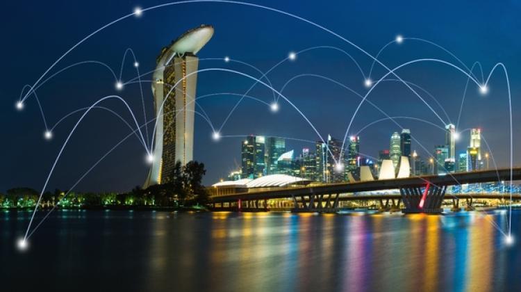 Image of Singapore's Marina Bay at night, overlaid on the image are a series of nodes and connection points representing digital networks